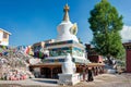 Tibetan pilgrims circle the Pagoda. Devotees walk 3 times around the Pagoda and Mani stone to accumulate karma (religious Royalty Free Stock Photo