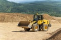 The Komatsu loader is working in an open pit.