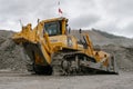 The Komatsu D375A bulldozer works in an open pit. It clears the road for mining machinery.