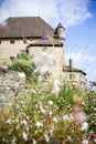 Medieval Yvoire Castle seen through a colourful flower garden. Royalty Free Stock Photo