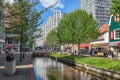 ZAANDAM, NETHERLANDS - April 26th, 2022: View to Gedempte Gracht street with canal and multiple shopping opportunities