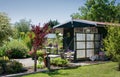 Garden shed with greenhouse surrounded by a beautiful decorative