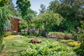 Garden shed surrounded by a beautiful decorative garden