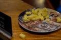 Zaanse Schans, Holland, August 2019. Tasting of typical Dutch cheeses: along the counter there are saucers with cubes of cheese to