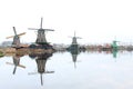 A CLASSIC WINDMILL REFLECTING AT THE CALM WATERS OF ZAANSE SCHANS