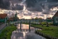 Zaanse Schans windmill landscape in the Netherlands, sunset cloudy sky