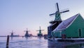 Zaanse Schans windmill village during winter with snow landscape in the Netherlands at sunrise Royalty Free Stock Photo