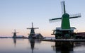 Zaanse Schans windmill village during winter with snow landscape in the Netherlands at sunrise Royalty Free Stock Photo