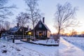 Zaanse Schans windmill village during winter with snow landscape in the Netherlands at sunrise Royalty Free Stock Photo