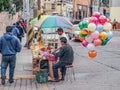 Zacatecas, Mexico. December 12th. . 2009. Street vendors selling fruit and colored balloons on a street corner