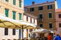 Zadar, Croatia; 07/17/2019: Facade of traditional croatian houses and parasols of the terraces of bars in the old town of Zadar