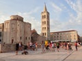 Zadar, Croatia - July 27, 2021: Church of St. Donatus and Bell tower. A square full of tourists