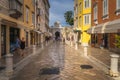 Tourists visiting beautiful narrow streets of the old town district of Zadar