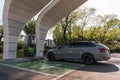 Skoda Superb Hybrid 2020 model Sport Line at charging station.