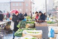 Zagreb, Croatia: January 7 2016: Female customer buying vegetables at Dolac market during wintertime with snow