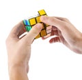 ZAGREB, CROATIA - MARCH 13, 2015: Hands solving Rubik's Cube. Rubik's Cube is invented by Erno Rubik in 1974. He is a Hungarian in