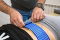 ZAGREB, CROATIA - May 28, 2019: Person getting muscle stimulator attached to her back