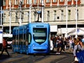 Zagreb, Croatia. Summer street. Tourists crossing the tram rails in downtown. streetcar approaching.