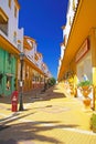 Beautiful atlantic coastal spanish town, empty pedastrian street, yellow colorful house facades, clear blue sky