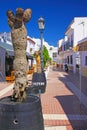 Idyllic quiet atlantic coastal town with white houses, small narrow alley with bars and restaurants, blue summer sky