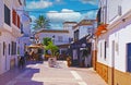 Idyllic quiet sleepy atlantic coastal town with white houses, pedestrian street, restaurant bar, blue summer sky