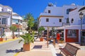 Traditianal beautiful quiet sleepy atlantic coastal town, palm trees, square with white houses, blue clear summer sky