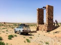 Zaida, Morocco - April 10, 2015. Old vintage silver off road car with travelers by stone water well in desert