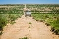 Zaida, Morocco - April 10, 2015. Silver vintage off road car fully loaded going in the dirt road in desert with green plants