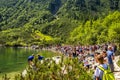 Zakopane, Poland - Crowds of tourists enjoying sunny weather and mountains scenery at the Morskie Oko pond in High Tatra Mountains