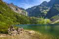 Zakopane, Poland - Crowds of tourists enjoying sunny weather and mountains scenery at the Morskie Oko pond in High Tatra Mountains