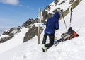 The skier prepares skis for riding.