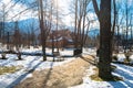 Zakopane, Poland - February 21, 2019. Park in the city covered with snow with a beautiful wooden house. Visible trees, sidewalk wi