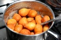 Zalabia in a stainless steel pot, a type of middle eastern fried dough similar to that of a doughnut, a tasty dessert