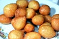 Zalabia on a white plate, a type of middle eastern fried dough similar to that of a doughnut, a tasty dessert