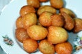 Zalabia on a white plate, a type of middle eastern fried dough similar to that of a doughnut, a tasty dessert