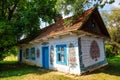 Colourful house with flowers painted on walls and sundial in the village of Zalipie, Poland. It