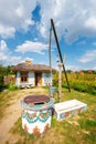 Traditional farmstead with a well in the colorful village of Zalipie, Poland. It is known for a