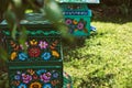 Wooden beehives decorated with painted flowers in polish village, Zalipie