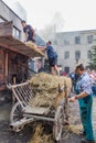 ZAMBERK, CZECHIA - SEPTEMBER 15, 2018: Threshing of grain in a wooden threshing machine in the Old Machines and Royalty Free Stock Photo