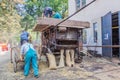 ZAMBERK, CZECHIA - SEPTEMBER 15, 2018: Threshing of grain in a wooden threshing machine in the Old Machines and Royalty Free Stock Photo