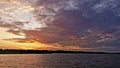 Zambezi River at sunset. Low clouds are colored by the setting sun in purple, orange, golden tones Royalty Free Stock Photo