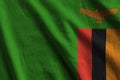 Zambia flag with big folds waving close up under the studio light indoors. The official symbols and colors in banner Royalty Free Stock Photo