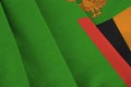 Zambia flag with big folds waving close up under the studio light indoors. The official symbols and colors in banner Royalty Free Stock Photo