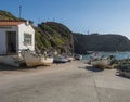 Zambujeira do Mar, Odemira, Portugal, October 27, 2021: fishing house and old rusty boats at small fishing port Entrada