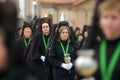 Zamora, Spain. Lady with a serious gesture next to her brotherhood sisters in the procession of the Virgin of Hope in Holy Week.
