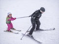 Zams, Austria - 22 Februar 2015: Ski resort. Mother and daughter ski on slope in Alps. Active sports vacation