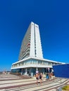 View over dutch seaside promenade on white modern north sea waterfront skyscraper, clear blue summer sky Royalty Free Stock Photo