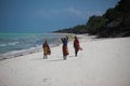 Zanzibar island local women walking on the beach