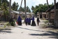 Zanzibar island local women walking through the village