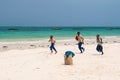 Zanzibar schoolboys running along the beach